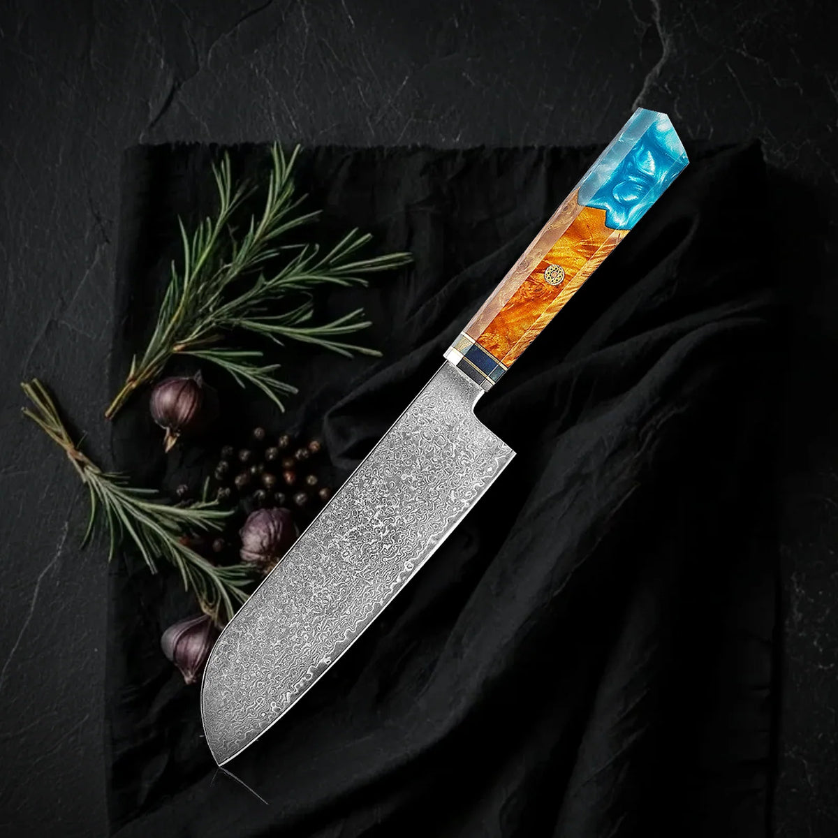 Santoku Kaen 18 cm: cuchillo multiusos japonés de acero damasco con mango octogonal de resina turquesa y madera, sobre tela negra con romero